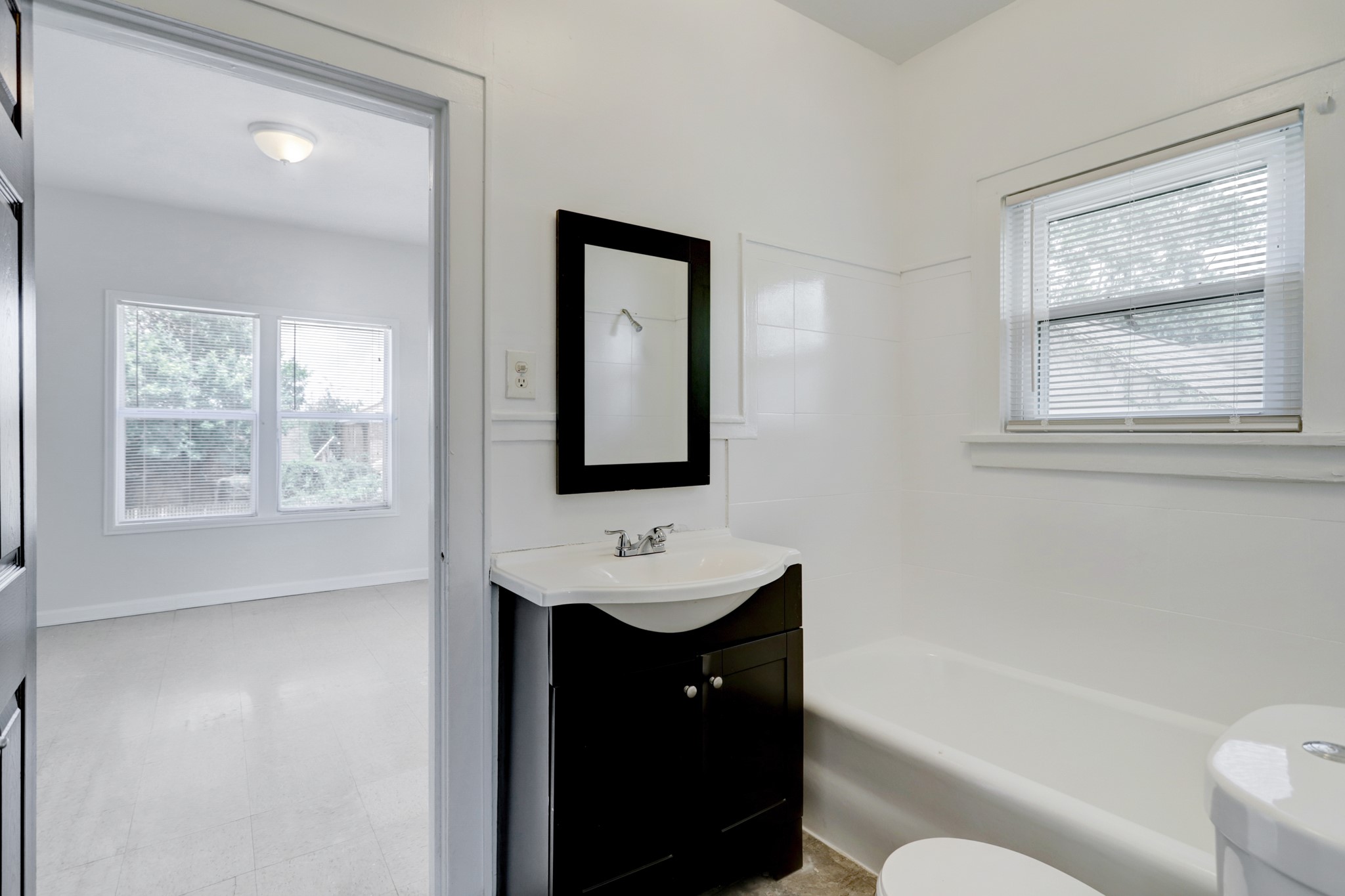 3002 Isabella Street Houston, TX 77004 - Photo 14 of 18 a bathroom with a toilet a sink and mirror