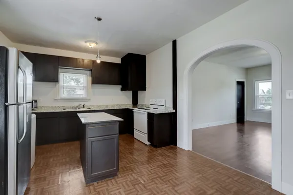 a kitchen with a refrigerator and a sink