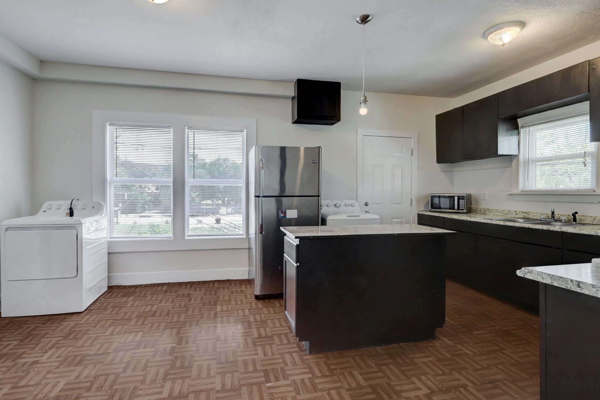 3002 Isabella Street Houston, TX 77004 - Photo 18 of 18 a kitchen with a sink and a stove top oven with wooden floor