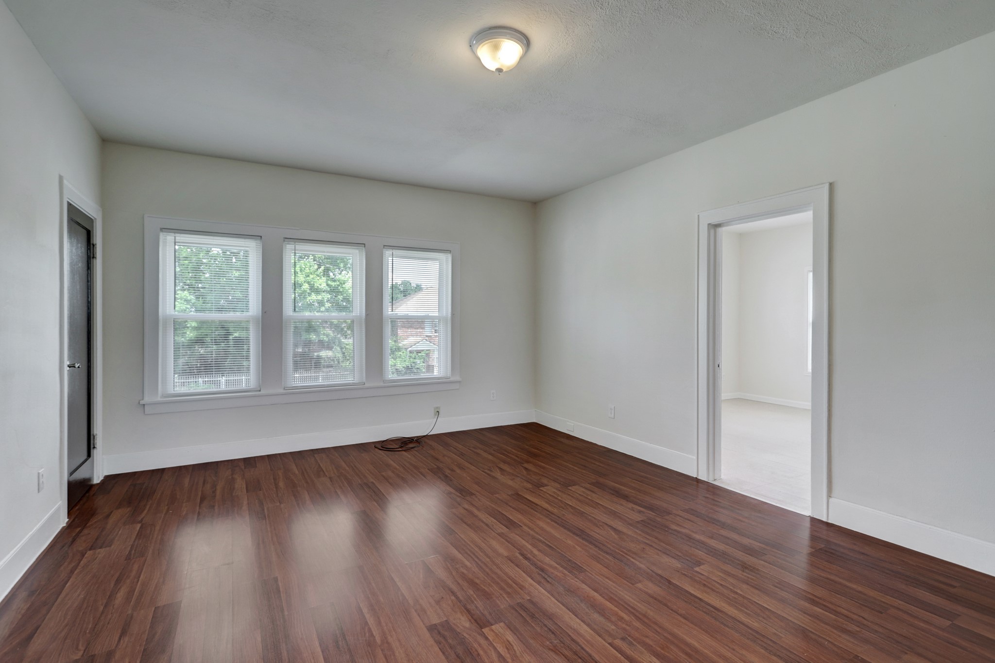 3002 Isabella Street Houston, TX 77004 - Photo 7 of 18 an empty room with wooden floor and windows