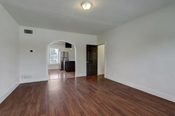 wooden floor in an empty room with a window