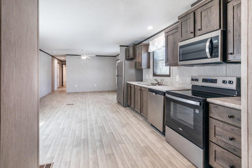 321 Beallsville Road Bentleyville, PA 15314 - Photo 11 of 26 a kitchen with stainless steel appliances kitchen island granite countertop a sink stove and microwave