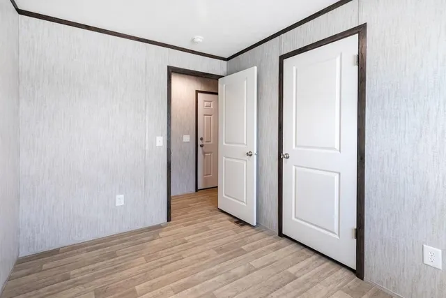 a view of hallway with wooden floor
