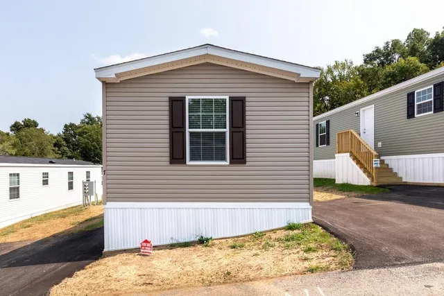 a view of a house with a wooden fence