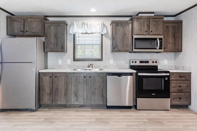 a kitchen with a sink cabinets and stainless steel appliances