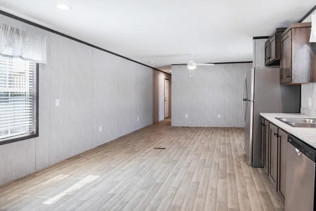 a view of a kitchen from a hallway