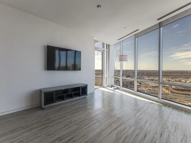 a view of a livingroom with furniture flat screen tv and wooden floor