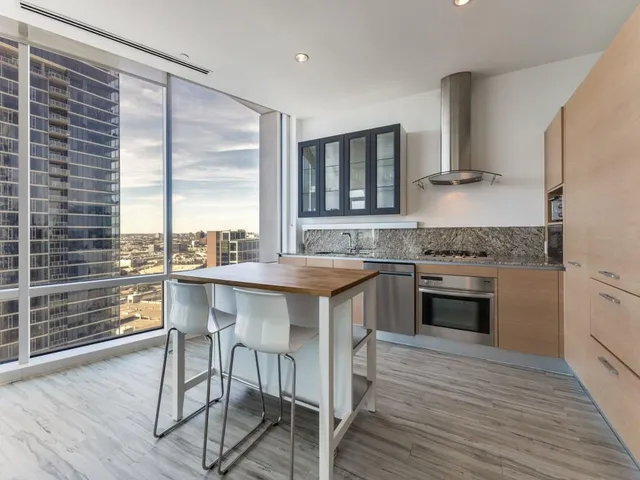 a kitchen with a stove a sink and a refrigerator