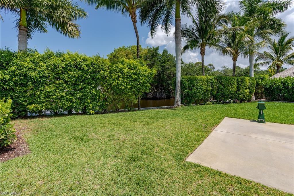 13375 Snook Circle Naples, FL 34114 - Photo 18 of 28 a view of a garden with a fountain