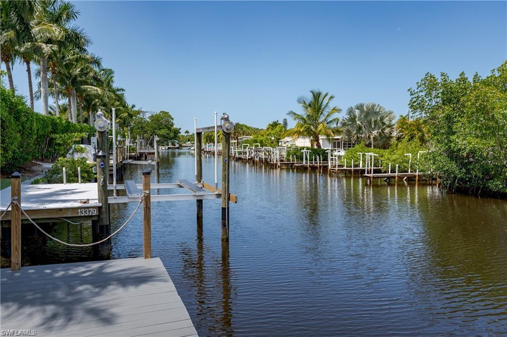 13375 Snook Circle Naples, FL 34114 - Photo 2 of 28 a view of a lake with boats in front of house