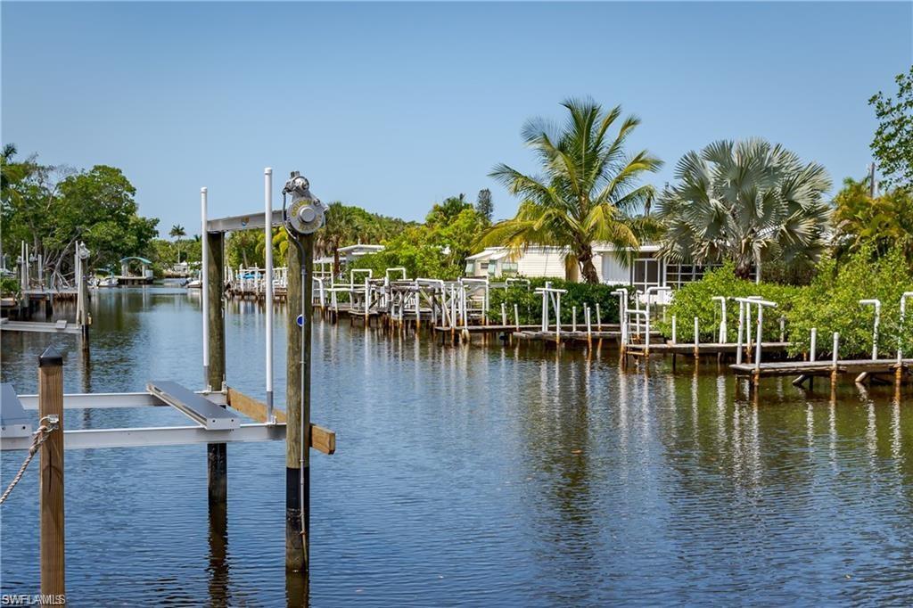 13375 Snook Circle Naples, FL 34114 - Photo 3 of 28 a view of a lake with boats and palm trees