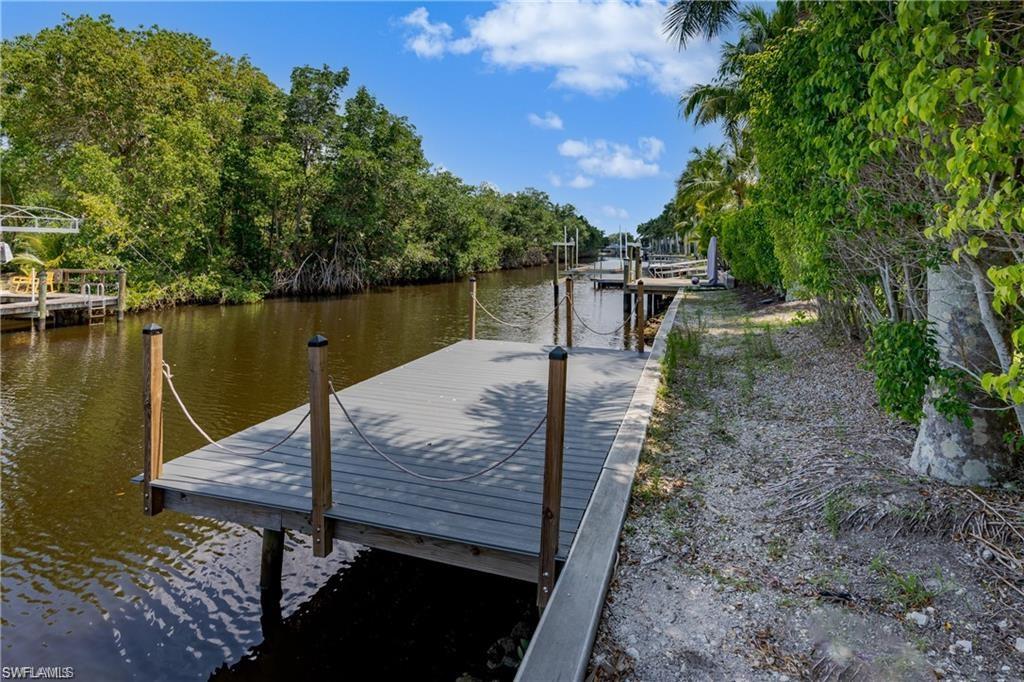 13375 Snook Circle Naples, FL 34114 - Photo 4 of 28 a view of a lake with a wooden deck