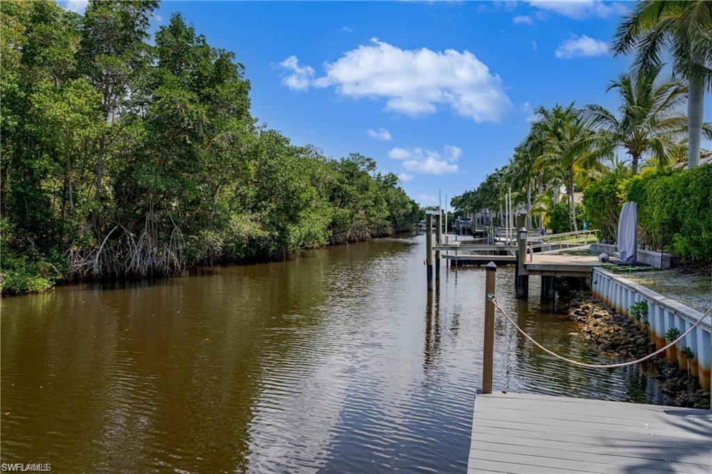 13375 Snook Circle Naples, FL 34114 - Photo 6 of 28 a view of a lake with wooden floor and lake view