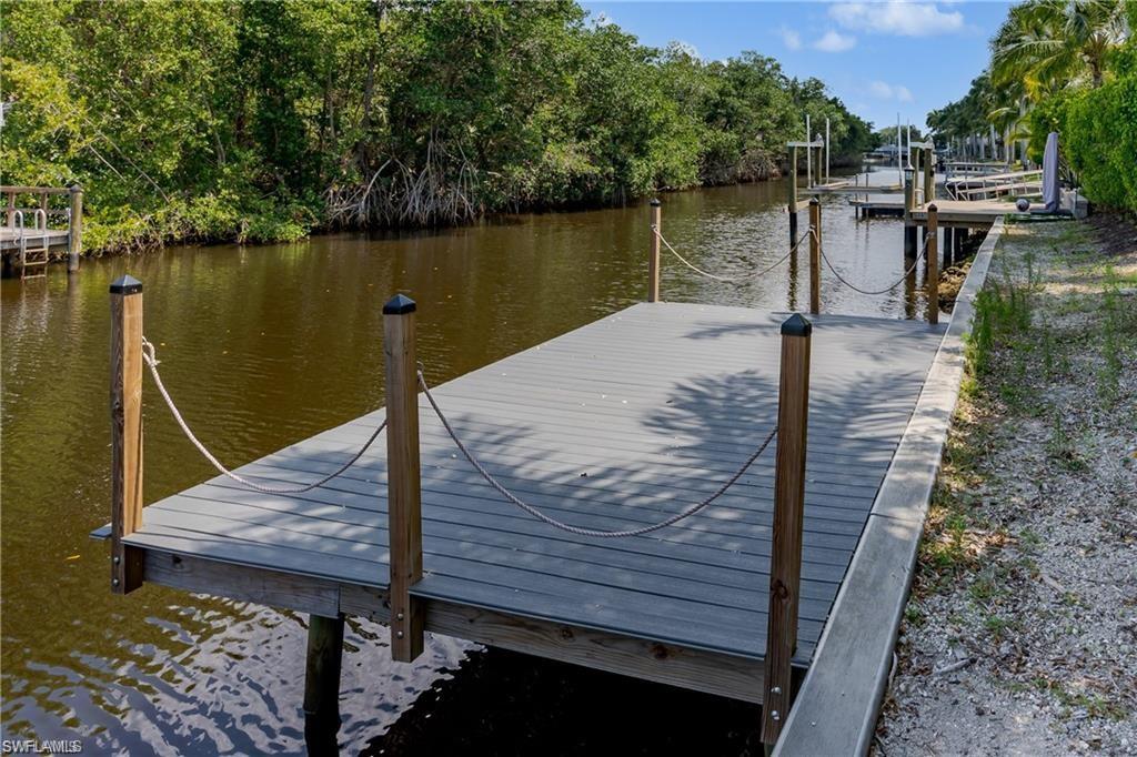 13375 Snook Circle Naples, FL 34114 - Photo 9 of 28 a view of a wooden deck with lake