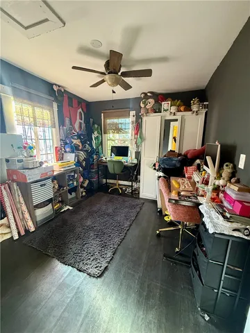 a living room with furniture a flat screen tv and a floor to ceiling window
