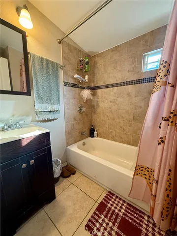 a bathroom with a sink a toilet a mirror and bathtub