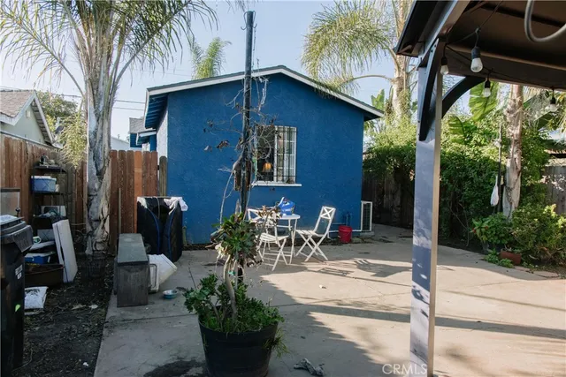 a view of a house with backyard and sitting area