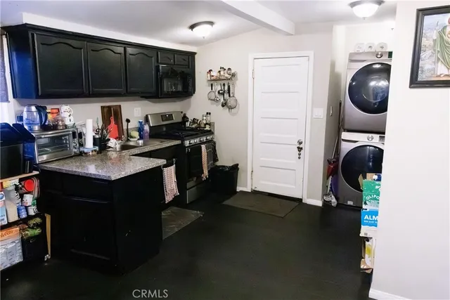 a kitchen with a sink cabinets and a stove top oven