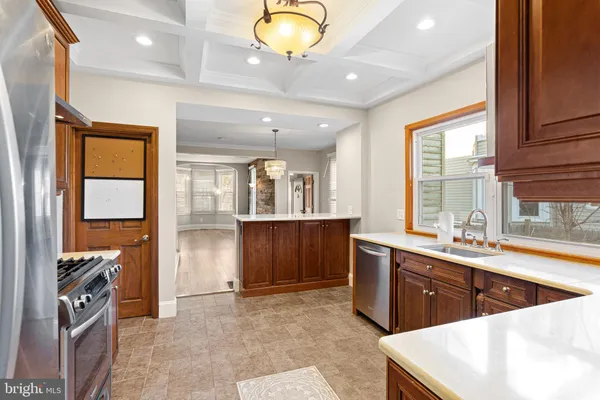 a kitchen with stainless steel appliances granite countertop a sink and a stove
