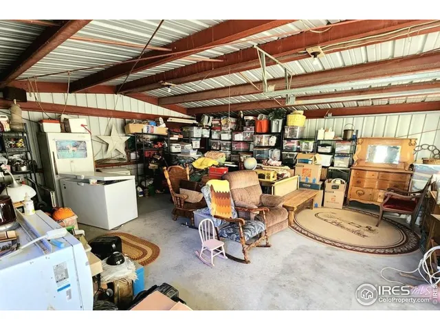 a room with lots of furniture and white walls