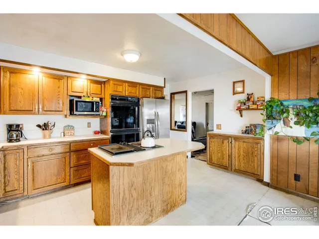 a kitchen with stainless steel appliances granite countertop a sink stove and a refrigerator