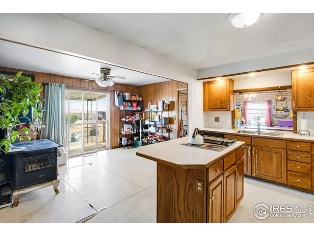 a kitchen that has a lot of cabinets a sink and a stove in it