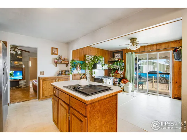 a kitchen with stainless steel appliances kitchen island granite countertop a stove a sink and a refrigerator