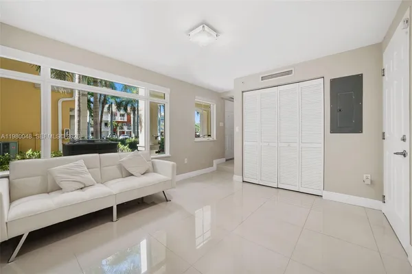 a living room with furniture and a large window