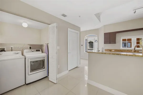 a view of a kitchen with washer and dryer