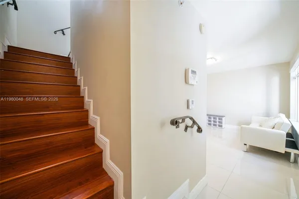 a bathroom with a bathtub and a hallway