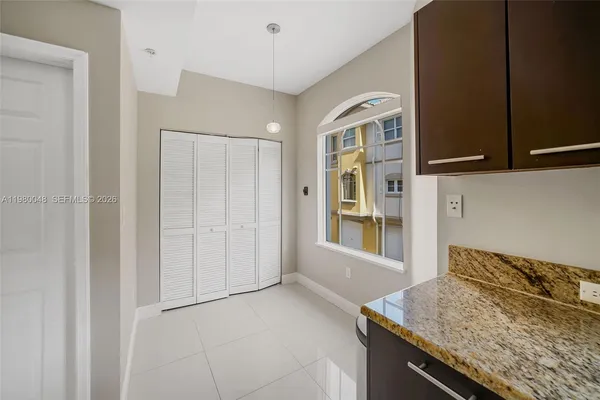 a kitchen with granite countertop cabinets and window