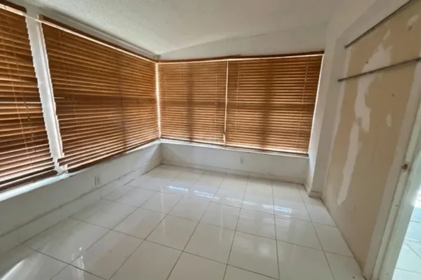 a view of an empty room with a window