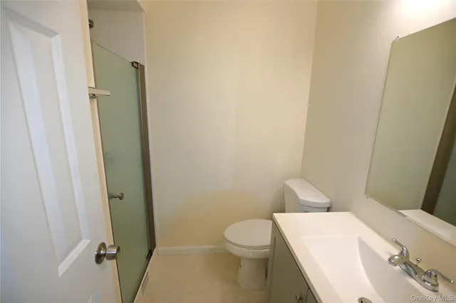 a white toilet sitting next to a bathroom sink