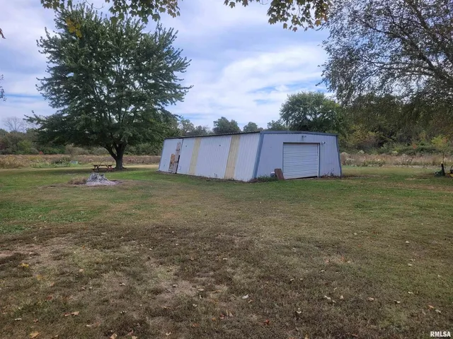 a view of a backyard with a small cabin