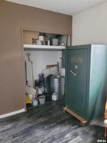 a storage room with wooden floor washer and dryer