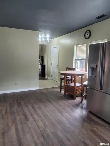 a livingroom with furniture wooden floor a fireplace and window