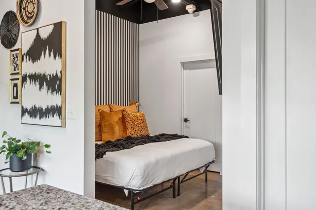 a bedroom with a bed and ceiling fan