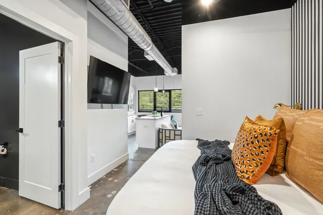 a bedroom with a bed and a flat screen tv