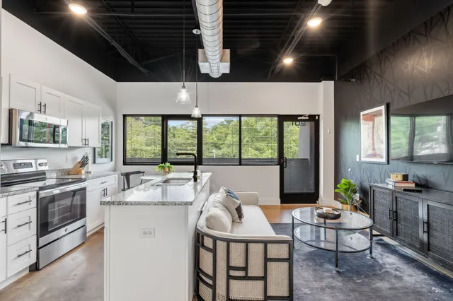 a kitchen with a stove and a white cabinets