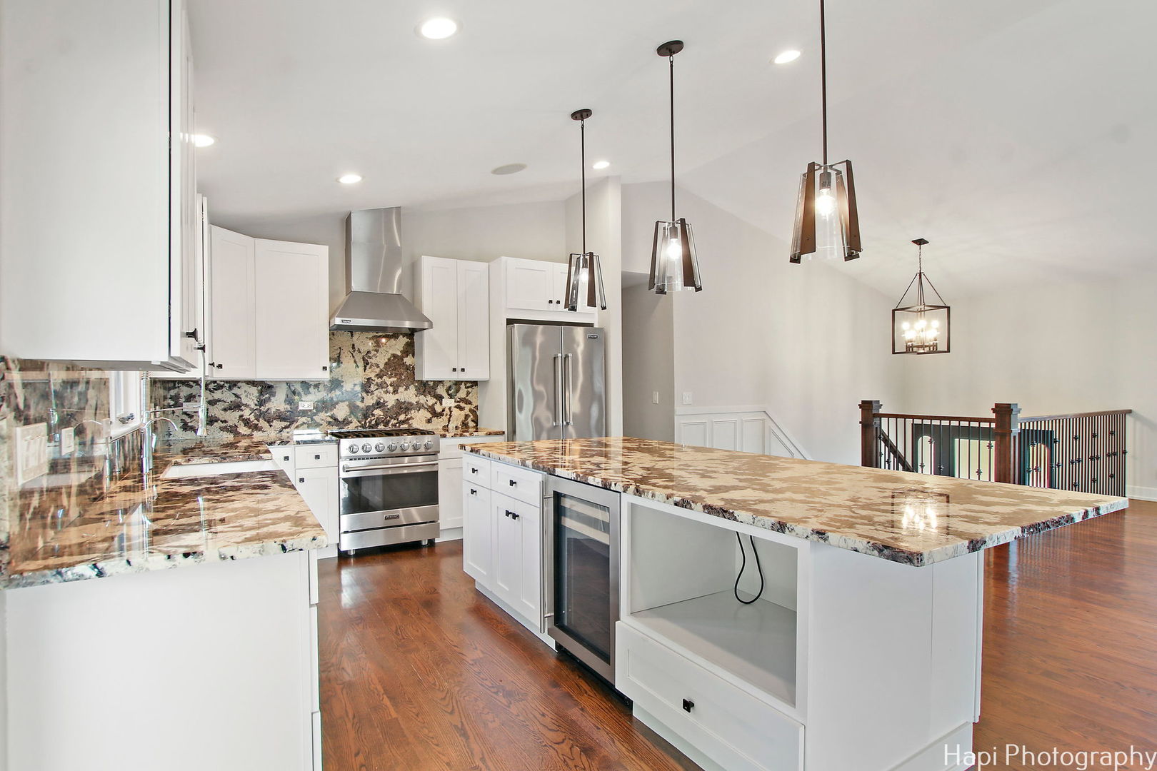 146 Harbor Drive Lake Barrington, IL 60010 - Photo 7 of 33 a kitchen with a stove a sink dishwasher a refrigerator and white cabinets with wooden floor