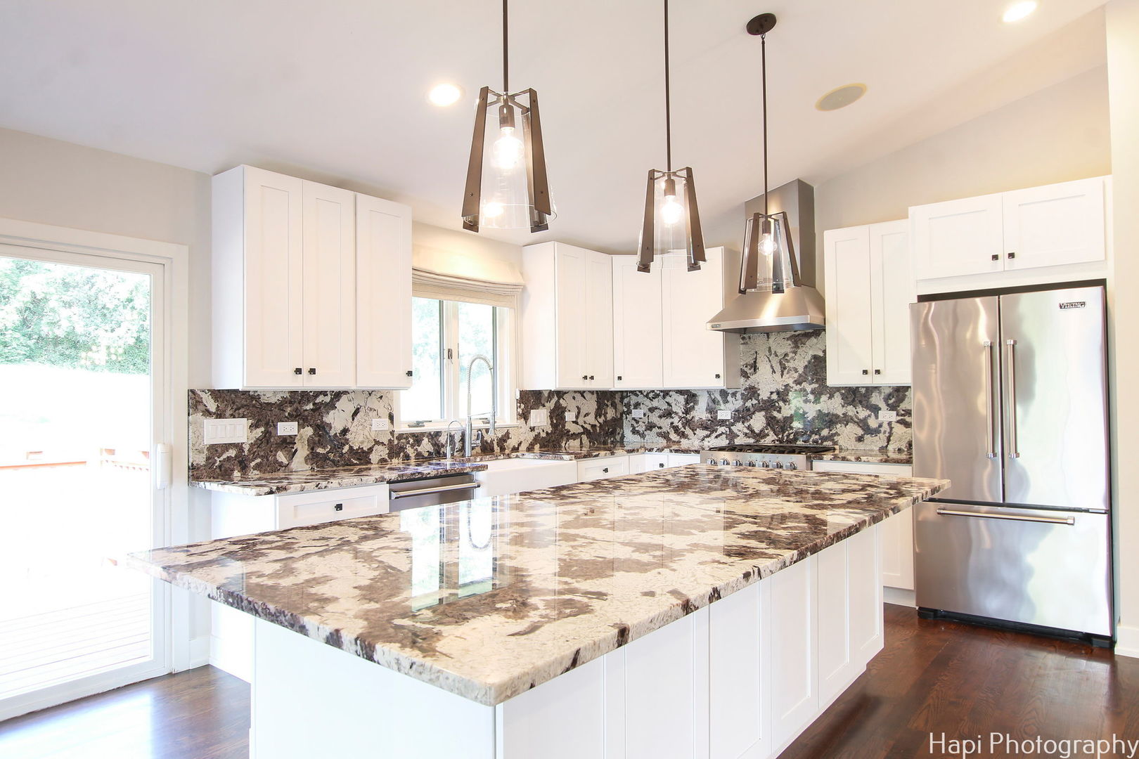 146 Harbor Drive Lake Barrington, IL 60010 - Photo 9 of 33 a kitchen with kitchen island granite countertop a sink a counter and a refrigerator