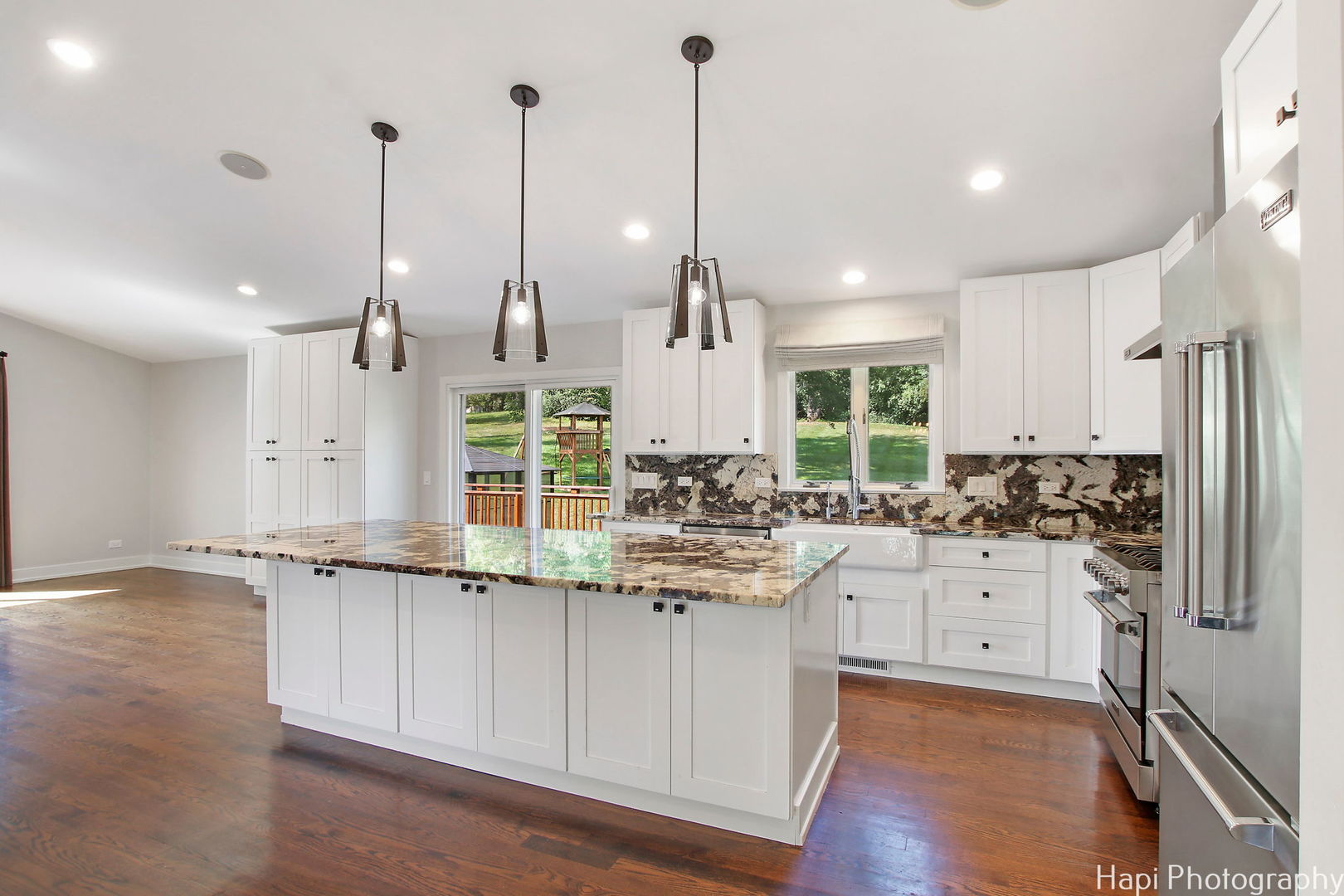 146 Harbor Drive Lake Barrington, IL 60010 - Photo 10 of 33 a kitchen with stainless steel appliances granite countertop a stove and white cabinets with wooden floor