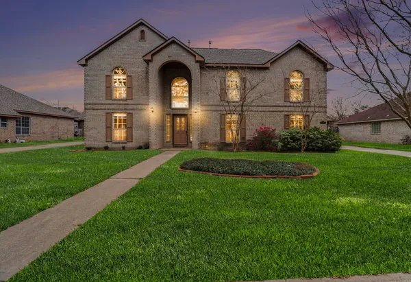 a front view of a house with a yard