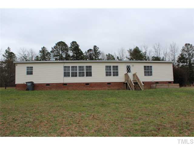 117 Vernon Hill Church Road Roxboro, NC 27574 - Photo 12 of 12 a view of a backyard with a garden and entertaining space