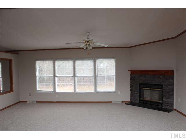 117 Vernon Hill Church Road Roxboro, NC 27574 - Photo 2 of 12 a view of an empty room with a fireplace and a window