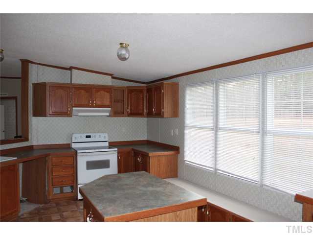 117 Vernon Hill Church Road Roxboro, NC 27574 - Photo 3 of 12 a kitchen with stainless steel appliances granite countertop a sink and cabinets