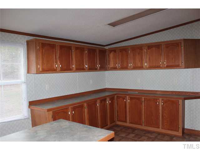 117 Vernon Hill Church Road Roxboro, NC 27574 - Photo 6 of 12 a kitchen with a sink and cabinets