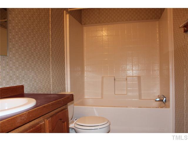 117 Vernon Hill Church Road Roxboro, NC 27574 - Photo 10 of 12 a bathroom with a sink a toilet and shower