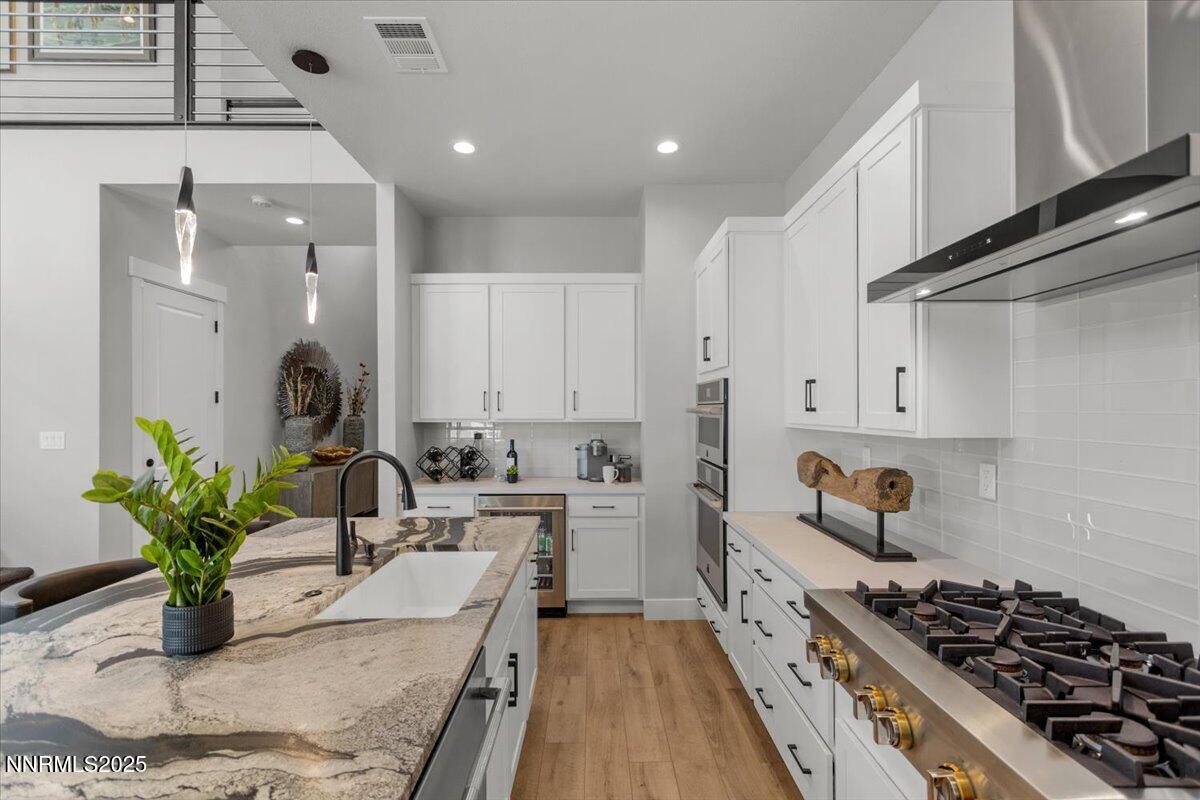 5517 Western Rider Trail Reno, NV 89511 - Photo 11 of 49 a kitchen with stainless steel appliances kitchen island granite countertop a sink a stove and cabinets