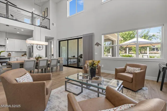 a living room with furniture a chandelier and a large window
